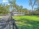 Picture of the horse paddock, with lush green grass and well-maintained fences, surrounded by mature trees at 965 Nw 73Rd Ter, Ocala, FL 34482