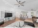 Spacious living room with high ceilings, ceiling fan, TV, and open access to kitchen at 965 Nw 73Rd Ter, Ocala, FL 34482