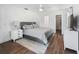 Cozy main bedroom with ceiling fan, neutral decor, and wood-look floors at 965 Nw 73Rd Ter, Ocala, FL 34482