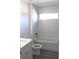 Bathroom with shower/tub combo, white tile, and grey flooring at 13441 Sw 113Th Pl, Dunnellon, FL 34432