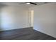 Cozy bedroom with neutral walls, wood-look flooring, ceiling fan and an open doorway at 13441 Sw 113Th Pl, Dunnellon, FL 34432