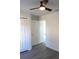 Bright bedroom showcasing a ceiling fan, closet and neutral walls with wood-look flooring at 13441 Sw 113Th Pl, Dunnellon, FL 34432