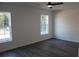 Inviting bedroom with ample natural light, featuring two windows and sleek vinyl flooring at 13441 Sw 113Th Pl, Dunnellon, FL 34432
