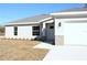 One-story house with gray siding, white door, and a stone accent at 13441 Sw 113Th Pl, Dunnellon, FL 34432