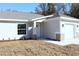 One-story house with gray siding, white garage door, and a stone accent at 13441 Sw 113Th Pl, Dunnellon, FL 34432