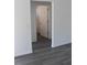 Hallway with wood-look flooring, leading to a bathroom at 13441 Sw 113Th Pl, Dunnellon, FL 34432