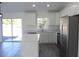 Bright kitchen featuring an island, stainless steel appliances, white cabinets and sliding doors leading to the backyard at 13441 Sw 113Th Pl, Dunnellon, FL 34432