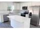Modern kitchen with white cabinets, stainless steel appliances, and a center island perfect for meal preparation at 13441 Sw 113Th Pl, Dunnellon, FL 34432