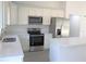 Modern kitchen with white cabinets and stainless steel appliances at 13441 Sw 113Th Pl, Dunnellon, FL 34432