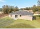 An aerial view of backyard with a well-manicured lawn, single sliding door and neutral exterior paint at 1877 Sw 150 Ct, Ocala, FL 34481