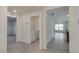 Hallway view showcasing access to the laundry room and a glimpse of the open living area at 3649 Sw 177Th Lane Rd, Ocala, FL 34473