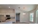 Dining area with tile floors, chandelier, and kitchen view at 7695 Sw 103Rd Loop, Ocala, FL 34476