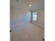 Bedroom features a large window and neutral carpeting at 7703 Sw 103Rd Loop, Ocala, FL 34476