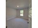 Bedroom with a large window and neutral carpeting at 7703 Sw 103Rd Loop, Ocala, FL 34476