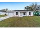 Attractive single-story home with a well-kept lawn, showcasing its inviting curb appeal and attached garage at 10177 Sw 137Th Ct, Dunnellon, FL 34432