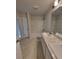 Bathroom featuring a double vanity with granite countertops, a tub, and an enclosed shower at 11503 Sw 65Th Avenue Rd, Ocala, FL 34476