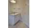 Bathroom with a stylish vanity, granite countertop, and wood-look tile flooring at 11503 Sw 65Th Avenue Rd, Ocala, FL 34476