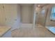 A luxury bathroom featuring a soaking tub, glass-enclosed shower, and neutral tiling at 11503 Sw 65Th Avenue Rd, Ocala, FL 34476