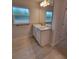 Bathroom with a stylish vanity, granite countertop, and wood-look tile flooring at 11503 Sw 65Th Avenue Rd, Ocala, FL 34476