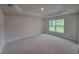 Spacious main bedroom featuring neutral color scheme, tray ceiling and carpet flooring at 11503 Sw 65Th Avenue Rd, Ocala, FL 34476