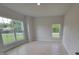 Light, bright bedroom with a large window overlooking the front yard and tile floors at 11503 Sw 65Th Avenue Rd, Ocala, FL 34476