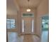 Welcoming foyer with decorative lighting, transom window and tile flooring, leads to other rooms at 11503 Sw 65Th Avenue Rd, Ocala, FL 34476
