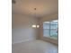 Bright living room boasts neutral paint, tile floors, and a modern chandelier at 11503 Sw 65Th Avenue Rd, Ocala, FL 34476