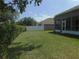 A spacious backyard with green grass, a white fence, and a covered sunroom at 4085 Sw 49Th Ave, Ocala, FL 34474