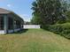 Spacious backyard with green grass, a white fence, and a covered sunroom at 4085 Sw 49Th Ave, Ocala, FL 34474