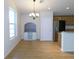 Open dining room with light hardwood floors, chandelier, and a custom-built storage cabinet at 4085 Sw 49Th Ave, Ocala, FL 34474