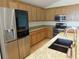 Updated kitchen with stainless steel appliances, granite countertops, wood cabinets, and modern fixtures at 4085 Sw 49Th Ave, Ocala, FL 34474