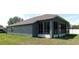 Back view of the house featuring a sunroom with wall-to-wall windows and a door at 4085 Sw 49Th Ave, Ocala, FL 34474
