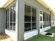 Back view of the house featuring a sunroom with wall-to-wall windows and a door at 4085 Sw 49Th Ave, Ocala, FL 34474