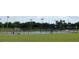 Community tennis court with a green playing surface and surrounding fence at 4085 Sw 49Th Ave, Ocala, FL 34474