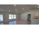 Open-concept living space adjacent to the kitchen, illuminated by recessed lighting and natural light at 7613 Sw 103Rd Loop, Ocala, FL 34476