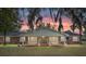 Brick ranch house with covered porch, under a sunset sky at 8544 Nw 160Th Ave, Morriston, FL 32668