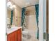 Bathroom with tub, shower, and teal shower curtain at 8718 Sw 83Rd Loop, Ocala, FL 34481