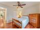 Well-lit bedroom featuring wood floors and a ceiling fan at 8718 Sw 83Rd Loop, Ocala, FL 34481