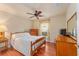 Bright bedroom with wood floors, a ceiling fan, and ample closet space at 8718 Sw 83Rd Loop, Ocala, FL 34481