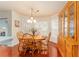 Bright dining room features a wood table and chairs, built-in hutch, and large windows at 8718 Sw 83Rd Loop, Ocala, FL 34481