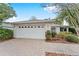 House exterior featuring a white garage door and paver driveway at 8718 Sw 83Rd Loop, Ocala, FL 34481