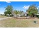 Single-story house with a red door and landscaped yard at 8718 Sw 83Rd Loop, Ocala, FL 34481