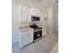 Modern kitchen boasts stainless steel appliances and stylish white cabinetry at 9679 Sw 46Th Ct, Ocala, FL 34476
