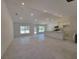 Open living room features large windows and tile floors and flows into the kitchen at 9679 Sw 46Th Ct, Ocala, FL 34476