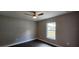 Bedroom with ceiling fan, neutral paint and wood-look floors at 14271 Se 33 Ter, Summerfield, FL 34491