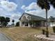 Beautiful building with a grand entrance, adorned with mature trees and a well-kept lawn at 5065 Nw 21St Loop, Ocala, FL 34482