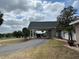 Well-maintained building with a covered entrance, showcasing landscaping and a driveway at 5065 Nw 21St Loop, Ocala, FL 34482