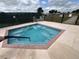 Relaxing outdoor hot tub with blue water, framed by a paved deck and black fencing at 5065 Nw 21St Loop, Ocala, FL 34482