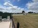 Exterior shot of the lawn bowling area with chairs, a bench and clear blue skies at 5065 Nw 21St Loop, Ocala, FL 34482