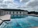 Outdoor swimming pool with lane markings, surrounded by a deck area and building at 5065 Nw 21St Loop, Ocala, FL 34482